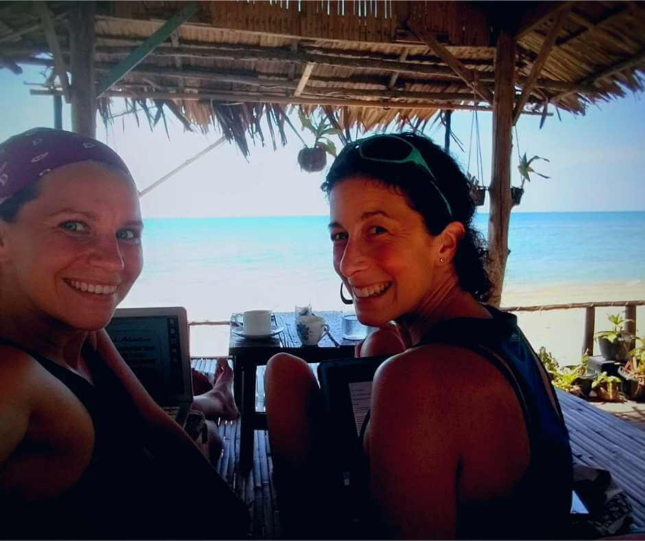 Iszy and Rachel working on trailor-made Ireland tours in a beach hut in Thailand